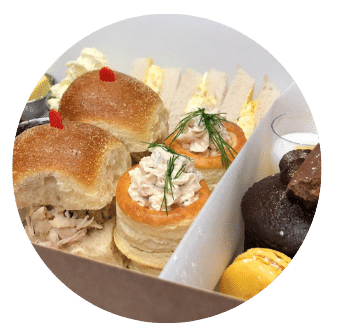 Afternoon Tea Dublin Chicken Brioche Sandwich, Egg and Cress Sandwich and Salmon and Cream Cheese Vol au vent in box Close up