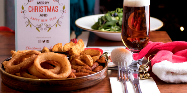 Christmas Party Platter Dublin with cocktail sauages, wedges, onion rings and more and glass of beer