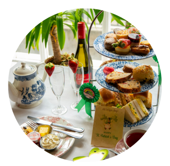 Savouries like chicken brioche, ham sandwich and salmon vol au vent themed for St Patricks Day on Shamrock Plates in Dublin