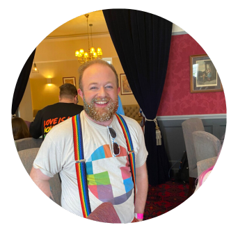 Man smiles in Old Music Shop Restaurant during pre Pride Parade breakfast