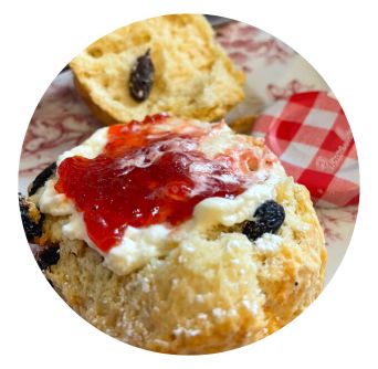 Scone lathered with jam and cream