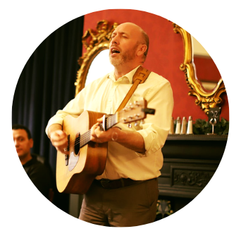 Singer with eyes closed playing guitar in Dublin. Old Music Shop Restaurant 2019