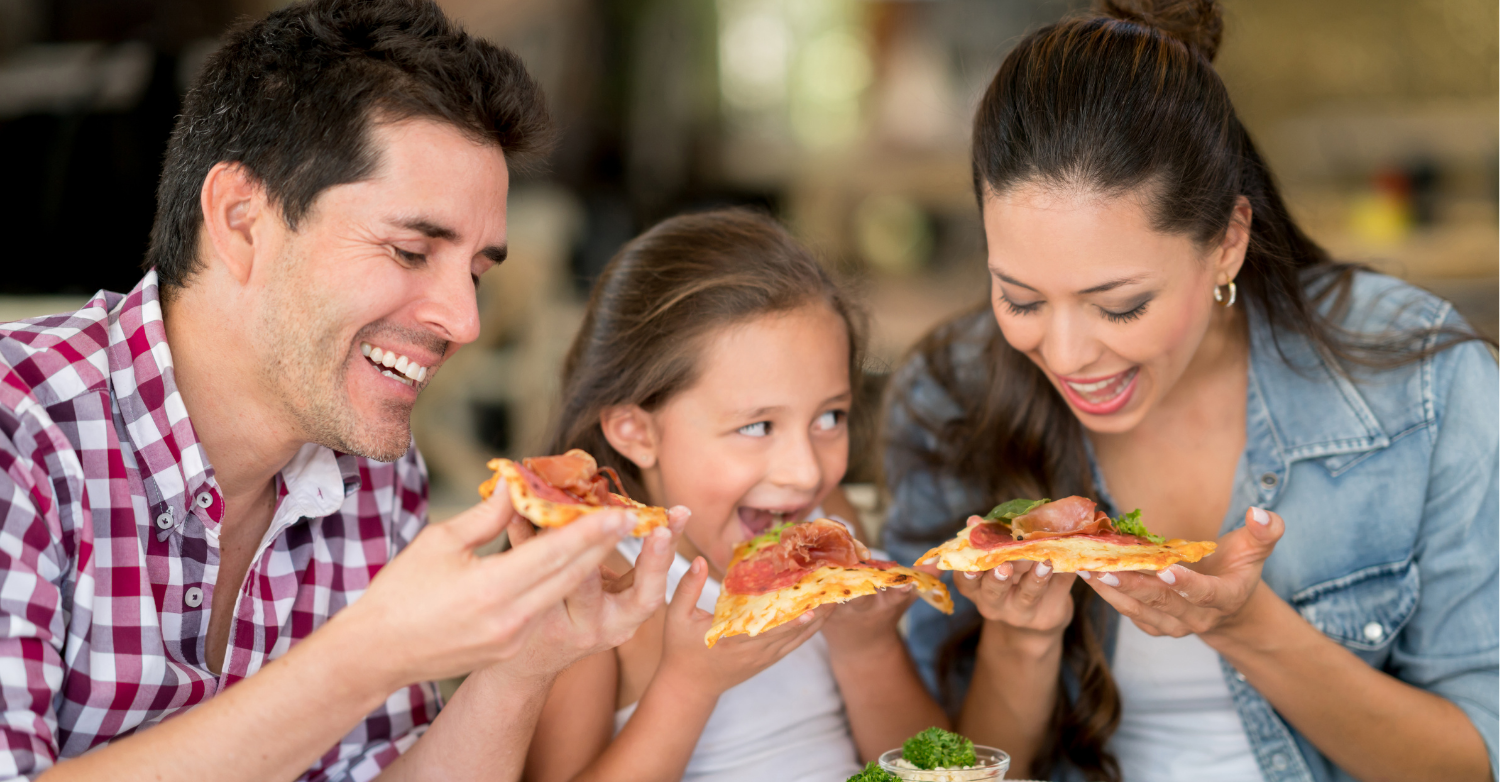 A family eating pizza in a restaurant
