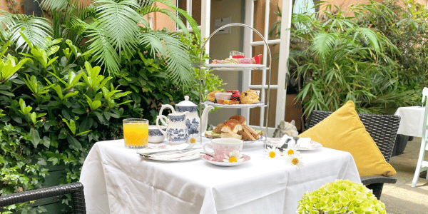 Vegetarian Afternoon Tea in Dublin on table with flowers and plants surrounding