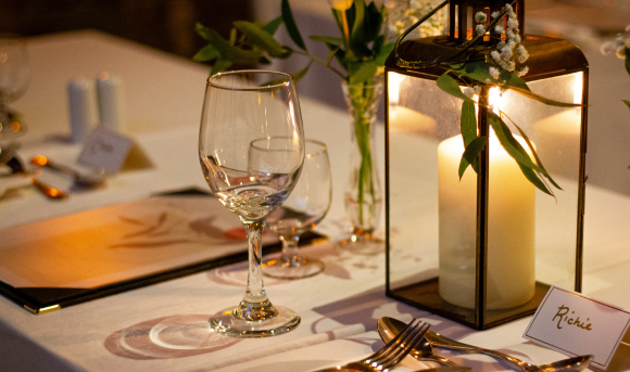 Glasses, Candle and name card for a small wedding table setting
