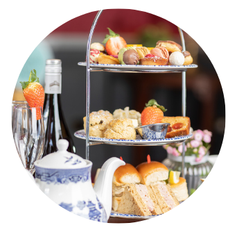 Traditional Afternoon Tea Stand with miniature scones, sandwiches and desserts with glasses of Prosecco in Old Music Shop Restaurant Dublin