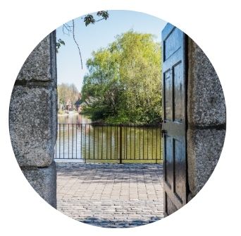 Old door way and stone wall opens out on to Blessington Basin Park near Old Music Shop Restaurant