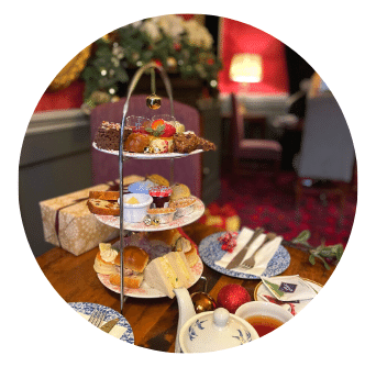 Festive Afternoon Tea in Dublin City Centre Restaurant with cosy lights and decorations. Selection of sandwiches, scones and cakes