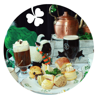 Irish Coffees and a Glass of Guinness in a St Patricks Day themed display with fluffy sheep and Afternoon Tea sandwiches and savouries on shamrock plates. 