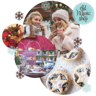 Beautiful girls in winter coats and hat, fireplace, tea stand, mince pies