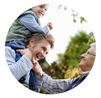 Grandfather, father with son on his shoulders all laughing. 