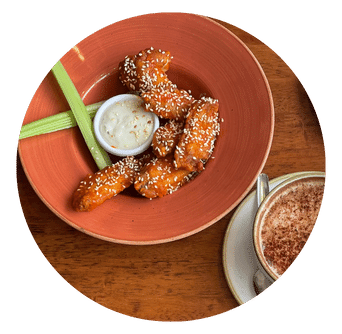 Chicken Wings with Sesame Seed in bowl with dip and celery sticks