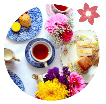 Mother's Day Afternoon Tea Take-Away Dublin Cup and Sandwiches and Flowers on fancy plates. 