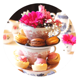 Macaroons on saucers stacked with tea cups and flowers for Mothers Day Afternoon Tea at Home Old Music Shop Restaurant Dublin 