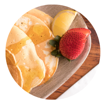 Stack of Old Music Shop Restaurant Pancakes with lemon, honey and strawberry
