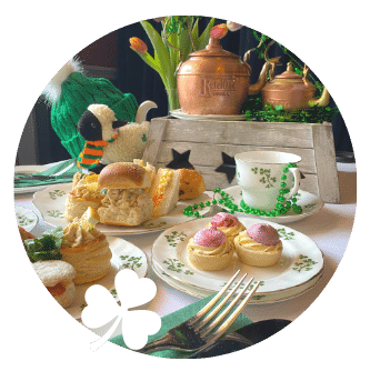 St Patricks Day Afternoon Tea from Old Music Shop lad out on white linen table cloth with shamrock china cups and plates